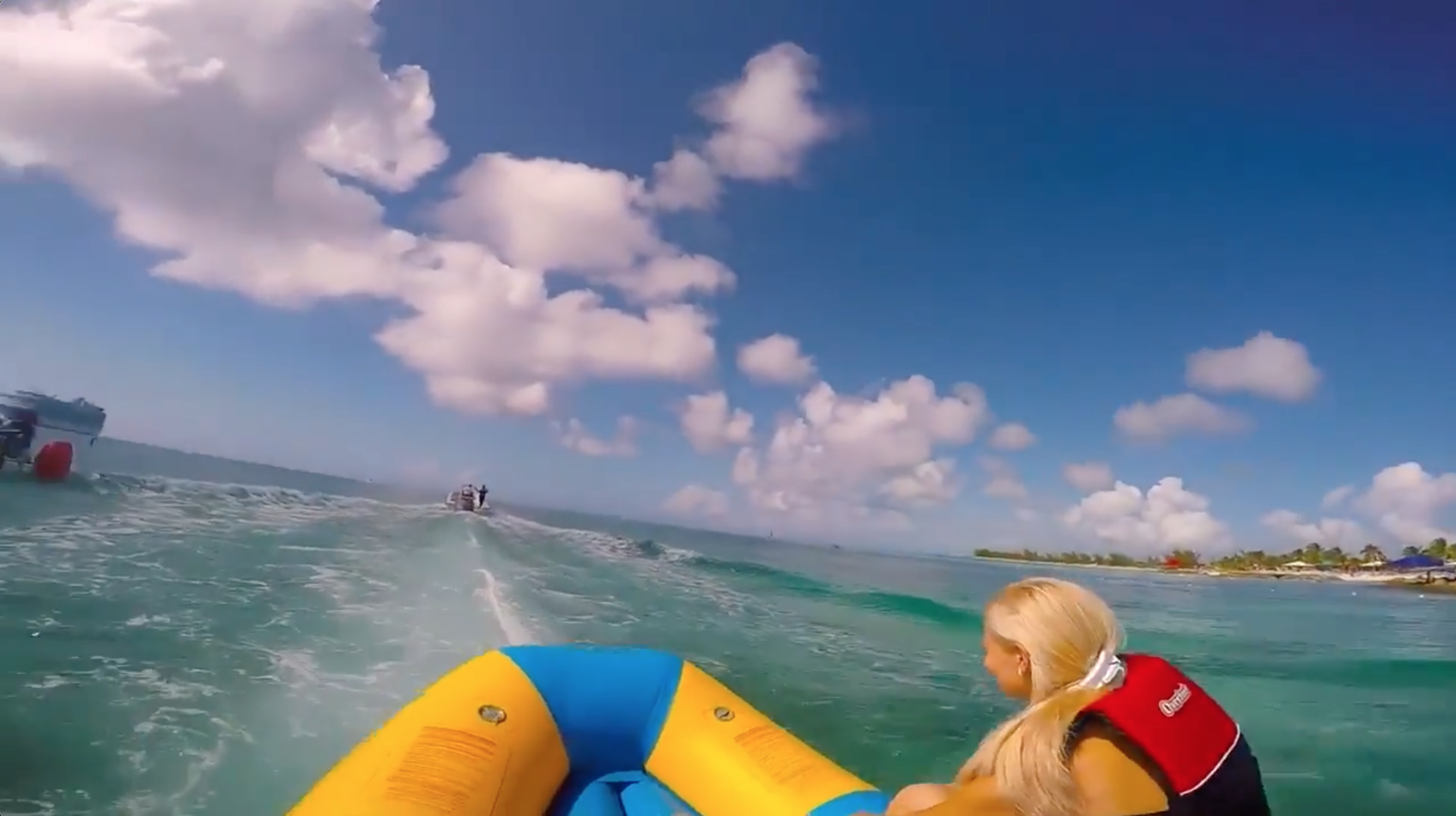 Guest riding a banana boat on Bahamian water